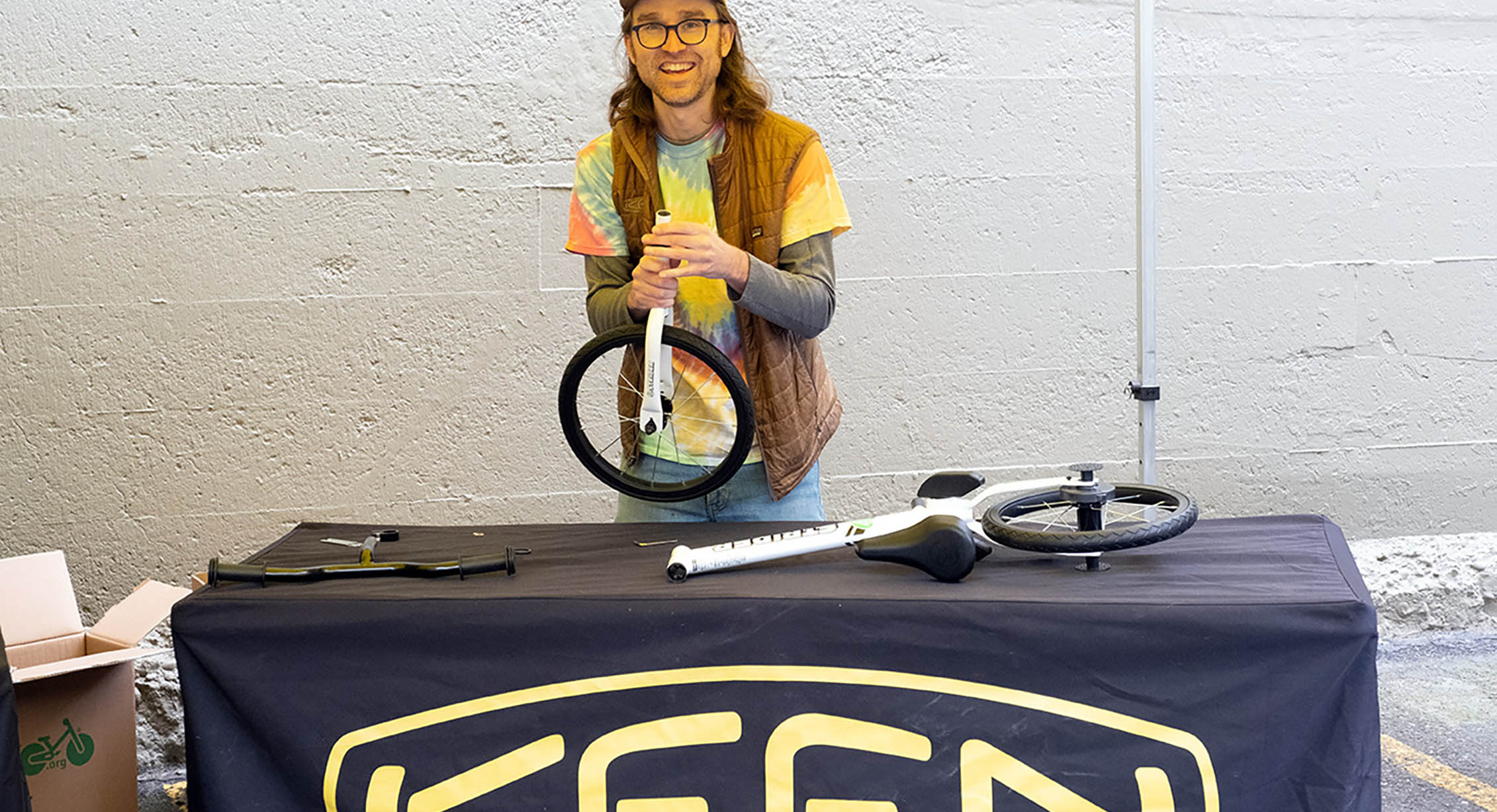 A KEEN employee building bikes for kindergartners
